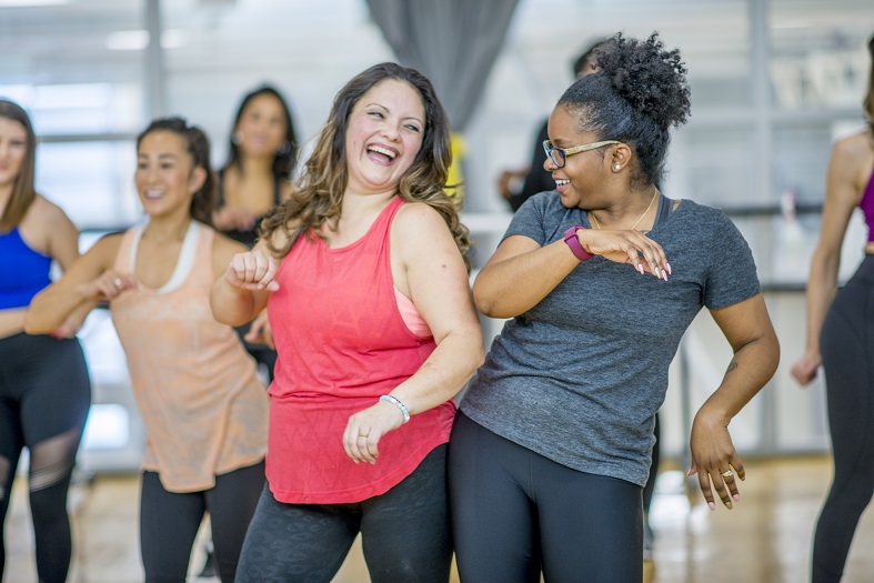 Group of women smiling and exercising
