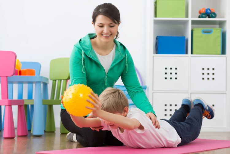 Child doing exercises with a physical therapist