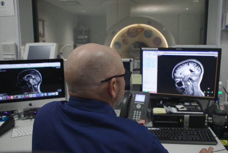 Man looking at MRI of a brain.