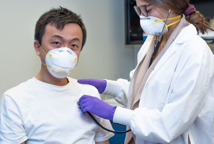 Patient wearing a mask with health care provider
