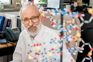 Image of Dr. Kendler with model of molecule