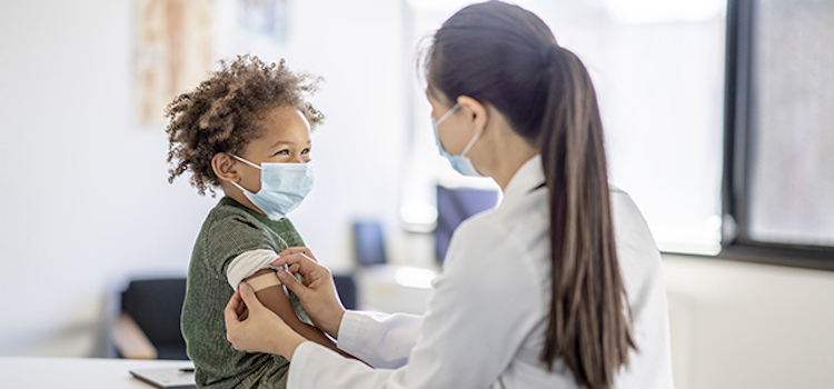 a child getting a band aid from a doctor